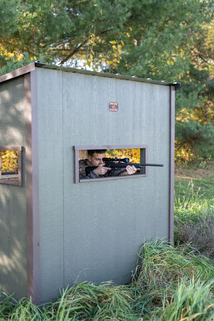 Hunter aiming gun through EZ Hunting Blind