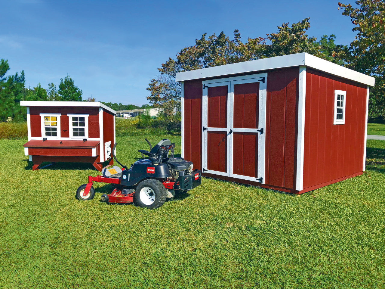 Shed Kit in a Box with lawn mower storage next to a large OverEZ Chicken Coop
